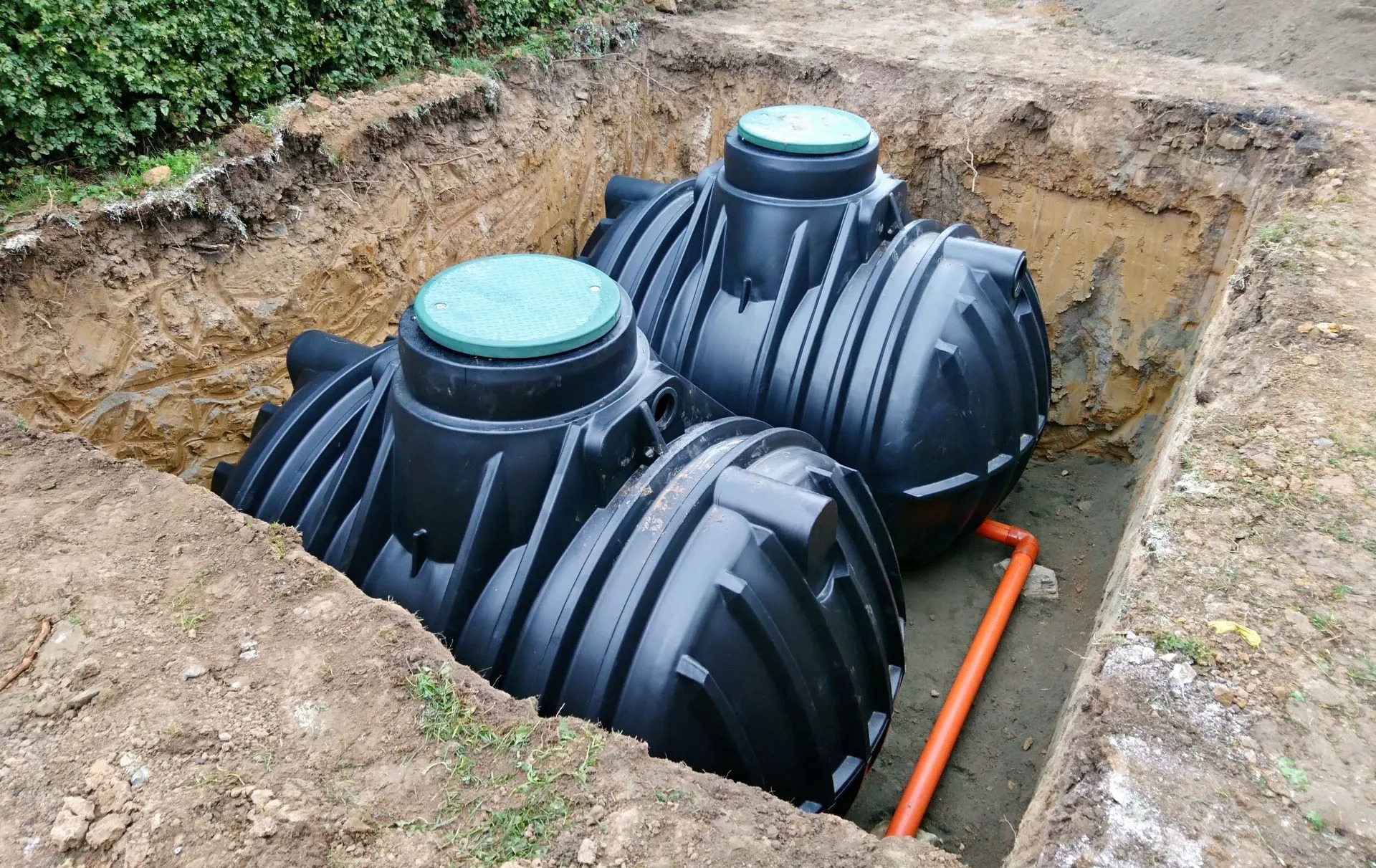 New septic tanks being set into an excavated bed